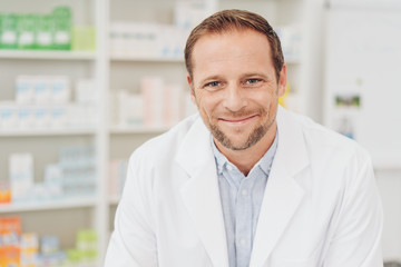 Smiling friendly pharmacist in a drugstore