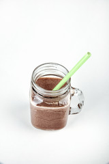 Fresh protein shake, milk with cocoa in a glass jar on a white background