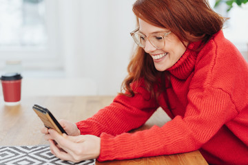 Young redhead woman with a happy grin