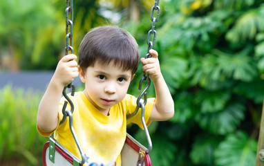 Happy children swinging