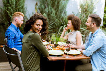 Cheerful young people have lunch in the courtyard and have a fun