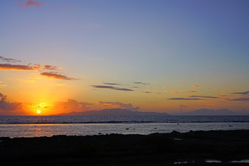 Sunrise view of the island and lagoon of Raiatea (Ra'iatea) near Tahiti seen from Bora Bora in French Polynesia, South Pacific