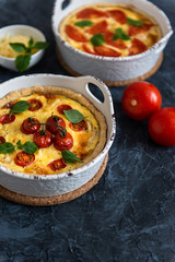 Vegetarian homemade pies, Quiche with tomatoes, basil leaves and cheese. copy space