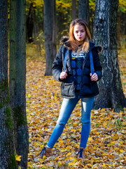 Happy Lifestyle portrait of a beautiful young model girl with a smile in a warm autumn clothes.