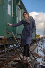 young woman in train station at sunny winter day