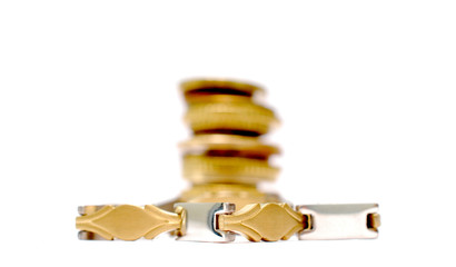 luxury bracelet in front of old coins, shallow dof image