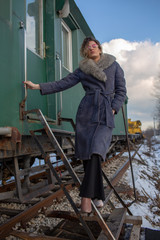 young woman in train station at sunny winter day