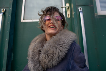 young woman in train station at sunny winter day