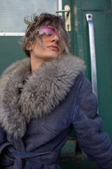 young woman in train station at sunny winter day