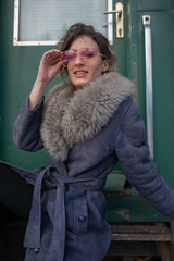 young woman in train station at sunny winter day