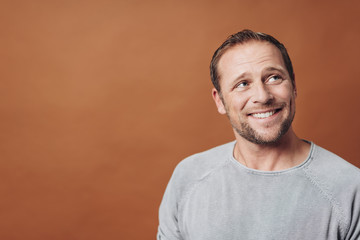 Smiling man looking away with copy space