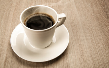 coffee still life from a cup of black coffee on a wooden table