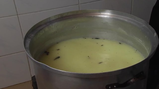 Flavor is added to traditional Halloumi cheese in a heated pot of brine