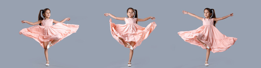 little girl in pink dress posing on gray background.