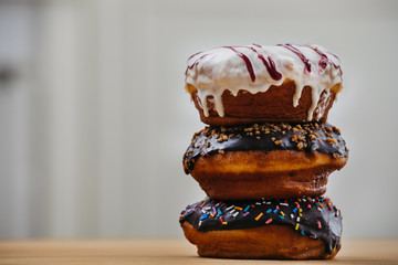 Doughnuts stacked on a wooden table