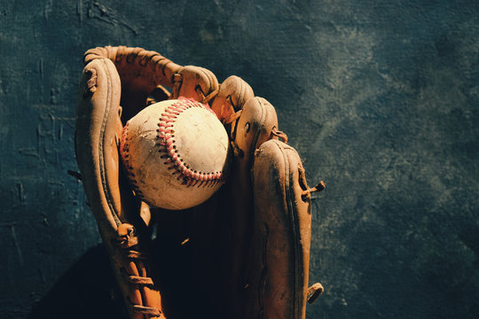 Baseball in old leather glove, shows ball and mitt for sports equipment with copy space.