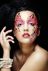 Closeup portrait of woman with artistic make-up. Luxury image.