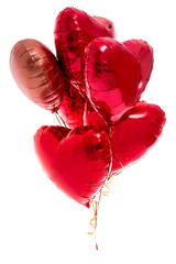 Valentine's day concept - bunch of red heart shaped foil balloons isolated on white