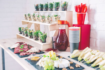 Catering buffet for events. Catering banquet table with different food snacks and appetizers with sandwich, salads, fresh fruits