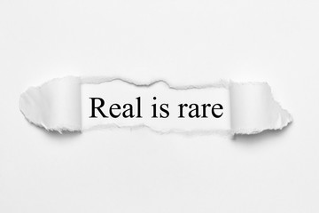 Real is rare on white torn paper