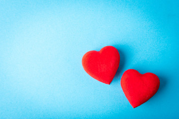 Naklejka na ściany i meble Red hearts on blue background.