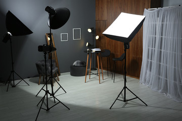 Example of living room interior design and professional equipment in photo studio