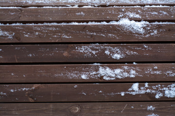 Winter wooden texture of wooden planks under the snow