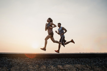 Young couple running on the street be running for exercise. fitness, sport, people, exercising...