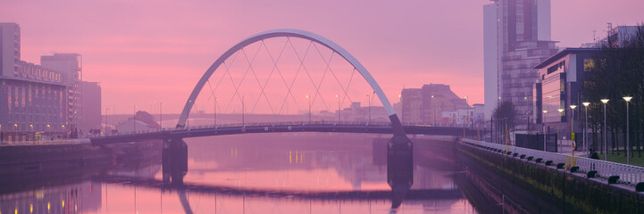 Fototapeta na wymiar The Clyde Arc (Squinty Bridge) above the River Clyde at sunrise on a winter morning.