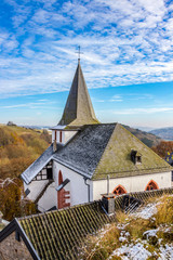 Elevated view of Saint John the Baptist Church in Kronenburg, North Rhine-Westphalia, Germany in winter