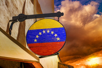 Flag of Venezuela on a wooden plaque hanging on an old building © Николай Батаев