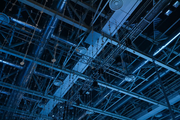 Fototapeta premium intersection of the construction beams in the blue light