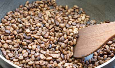 Roasted coffee beans in a pan, Traditional techniques.