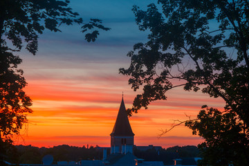 Summer sunset and beautiful sky above the historical part of Tartu, Estonia. Jaani kirik (St. John's Church) in the center. View from the Dome hill.