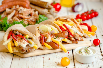 Assorted tortilla wraps with meat, sausages, cheese