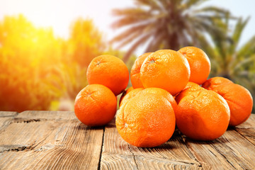 Fototapeta na wymiar Juicy oranges on a wooden table in the hot Spanish sun 