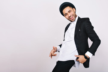 Stylish smiled guy in suit, hat having fun on white background. Leisure, cheerful mood, joy,...