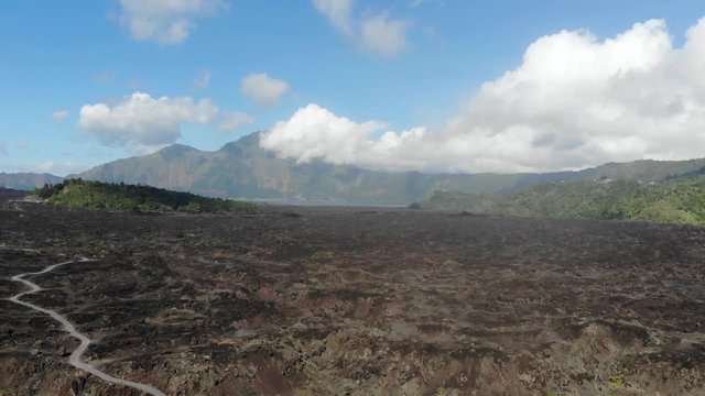 Aerial photography near the Batur volcano in the North of Bali. Around the frozen lava that burned everything around.