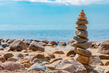 Fototapeta na wymiar Zen pyramid of stones on seashore.Concept harmony and balance,spa and yoga