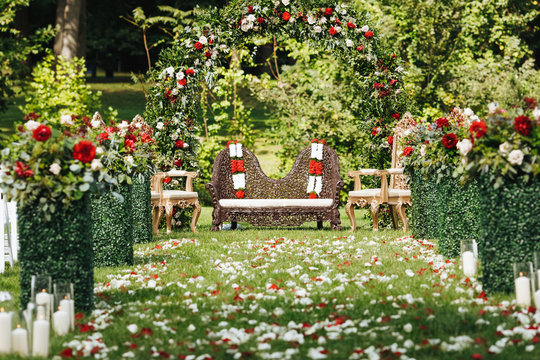 Rose petals cover green garden ready for traditional Hindu wedding ceremony