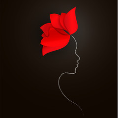 Bright red flower and a silhouette of a woman's face on a black background