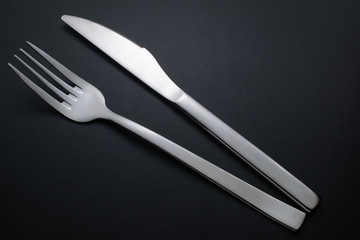 knife and fork on black background