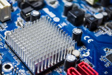 The old motherboard from the computer of blue color. Texture. Spare parts. Repair. Personal...