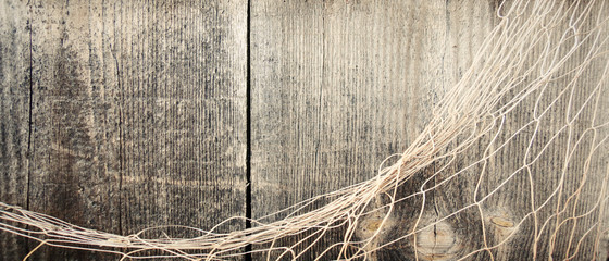 Fishing nets on the wooden background.