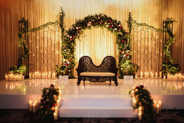 Black sofa for Hindu wedding creremony stands on the stage