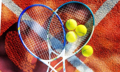 Tennis game. Tennis balls and rackets on  background.