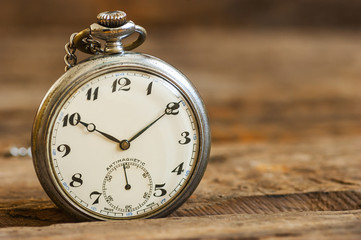 1970 s ancient, old pocket watch and chain, vintage locket watch on chestnut rustic wooden...