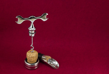 glamorous wine set with a corkscrew on a burgundy background