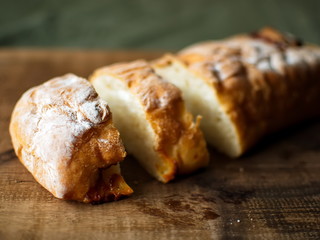 Ciabatta. homemade italian ciabatta bread top view. Bread with cheese. Sliced fresh bread on a wooden tray.
