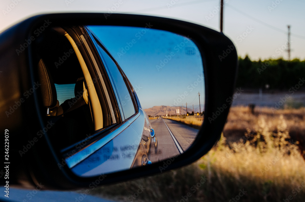 Poster Traveling in California by car. View in the side mirror